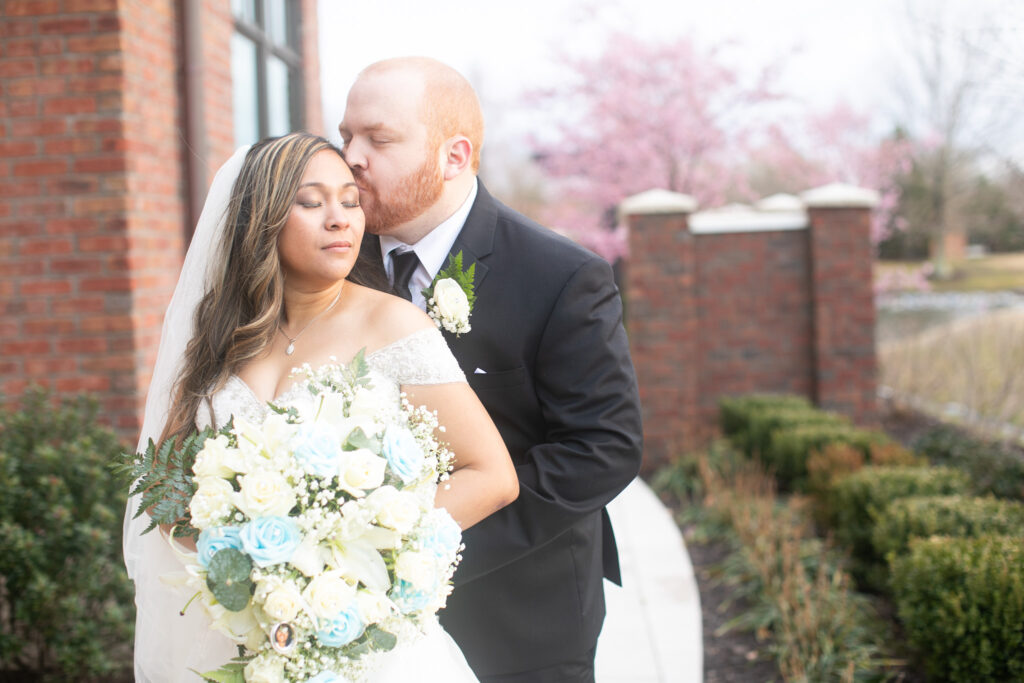 Bride and groom kissing at Noah's event venue