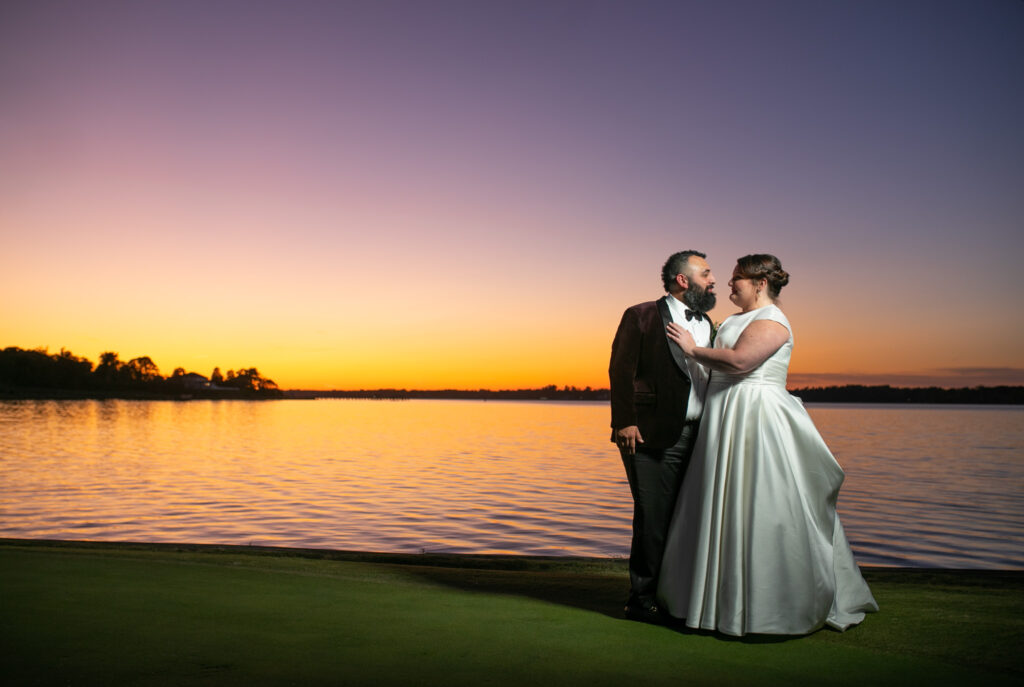 bride and groom near water